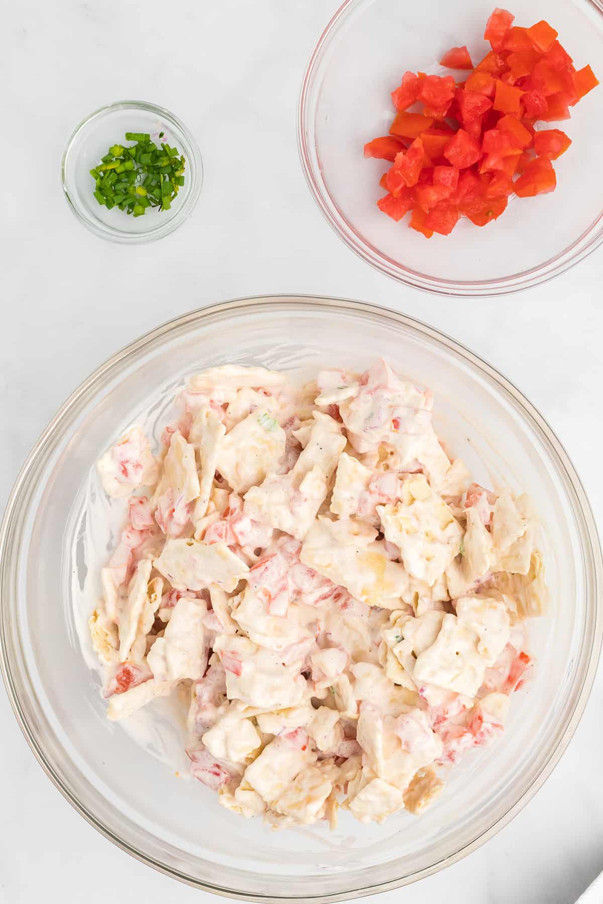 Broken crackers added to tomato and mayonnaise mixture.