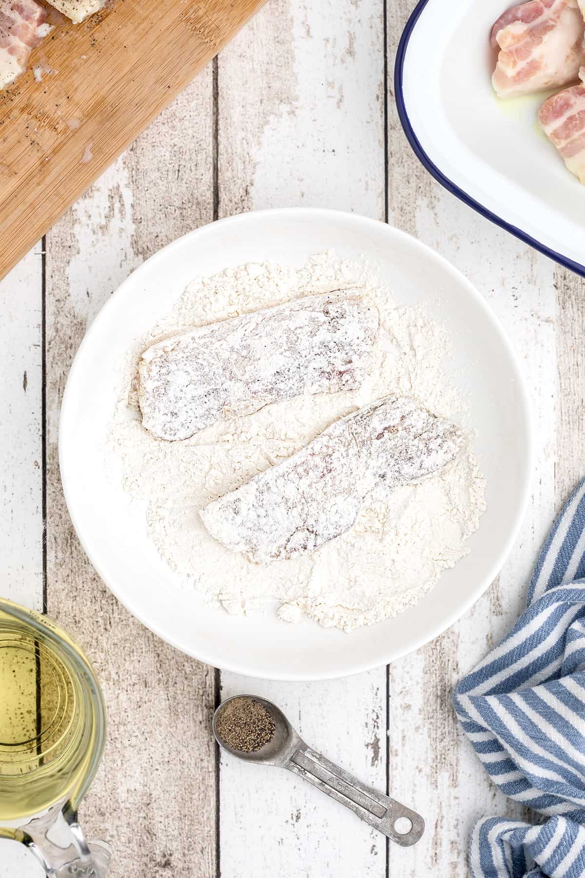 Salt pork in a dish with flour.