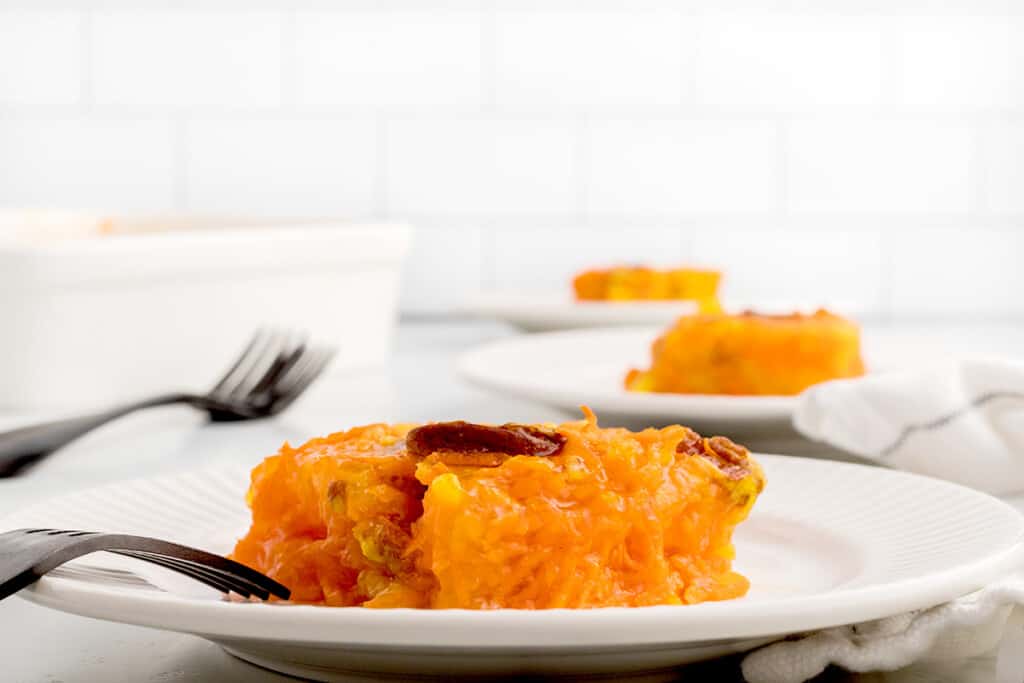 A serving of jello salad on a white plate.