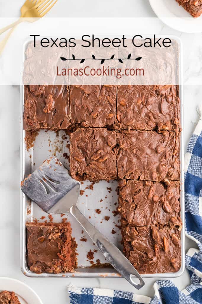 Cake squares cut on a baking sheet with a spatula to the side.