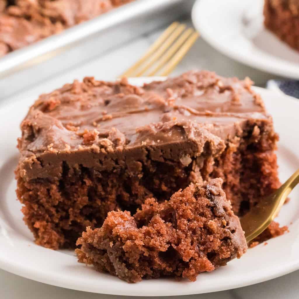 A individual serving of cake on a white plate.