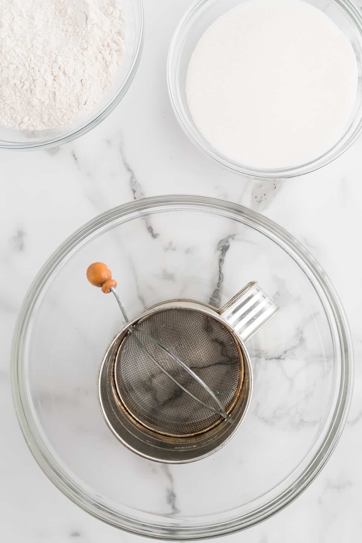 A sifter in a mixing bowl.