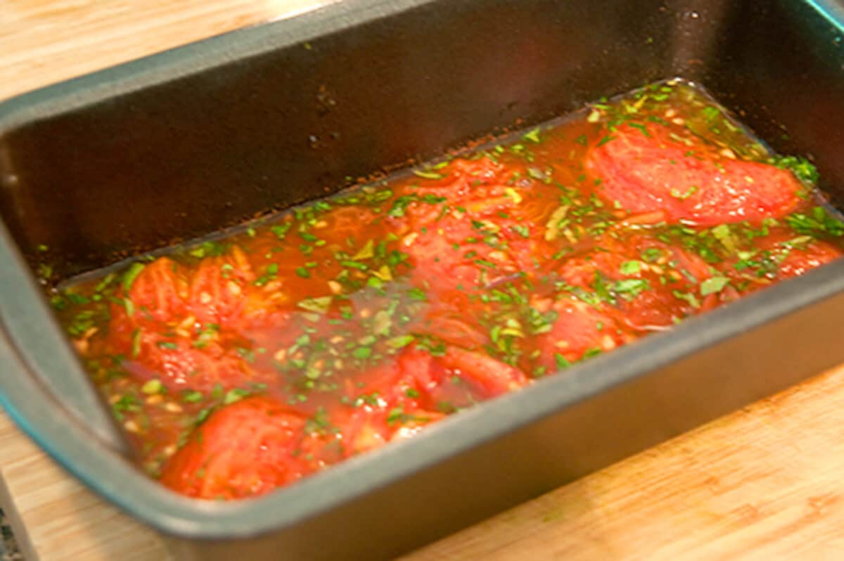 Aspic mixture in a loaf pan.