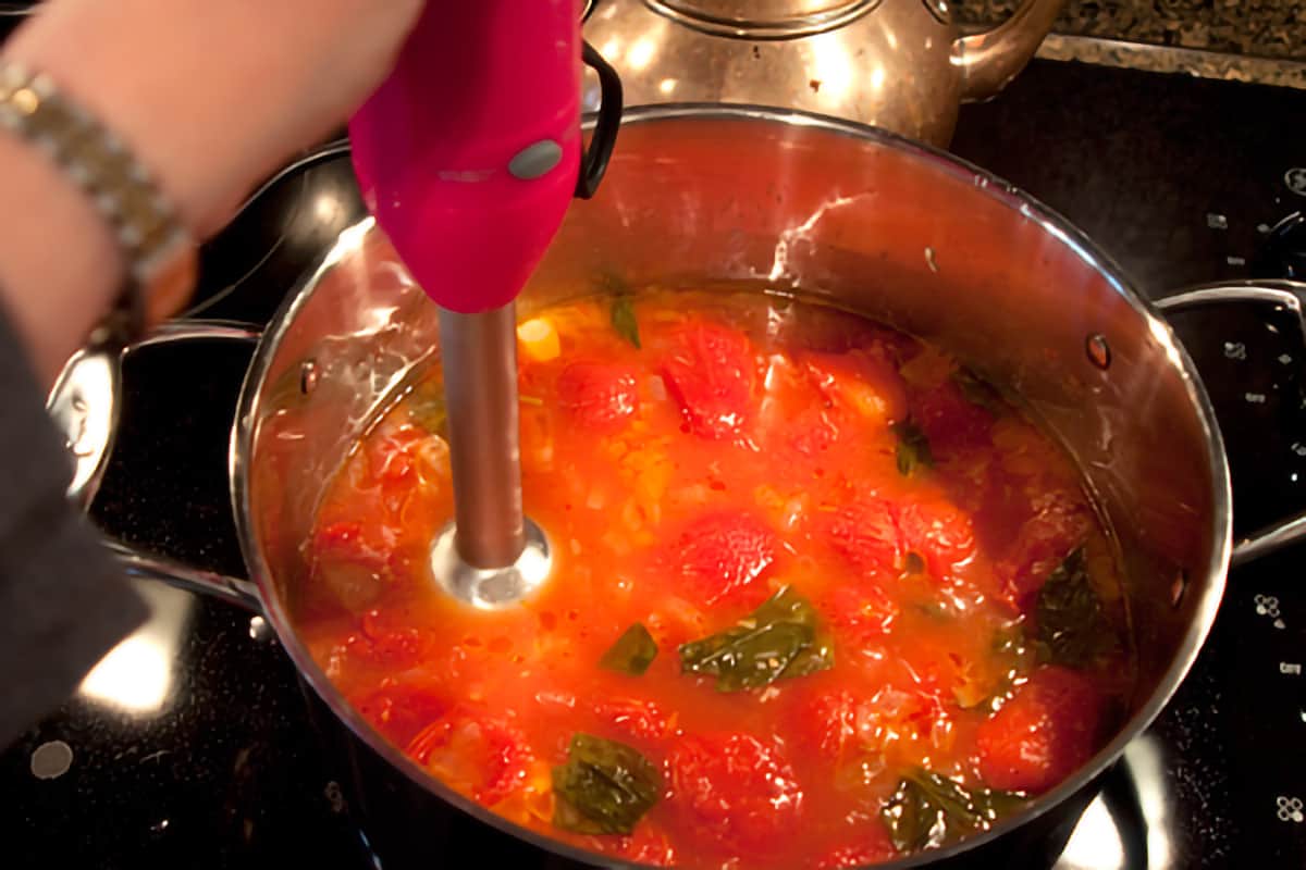 Pureeing soup with stick blender.