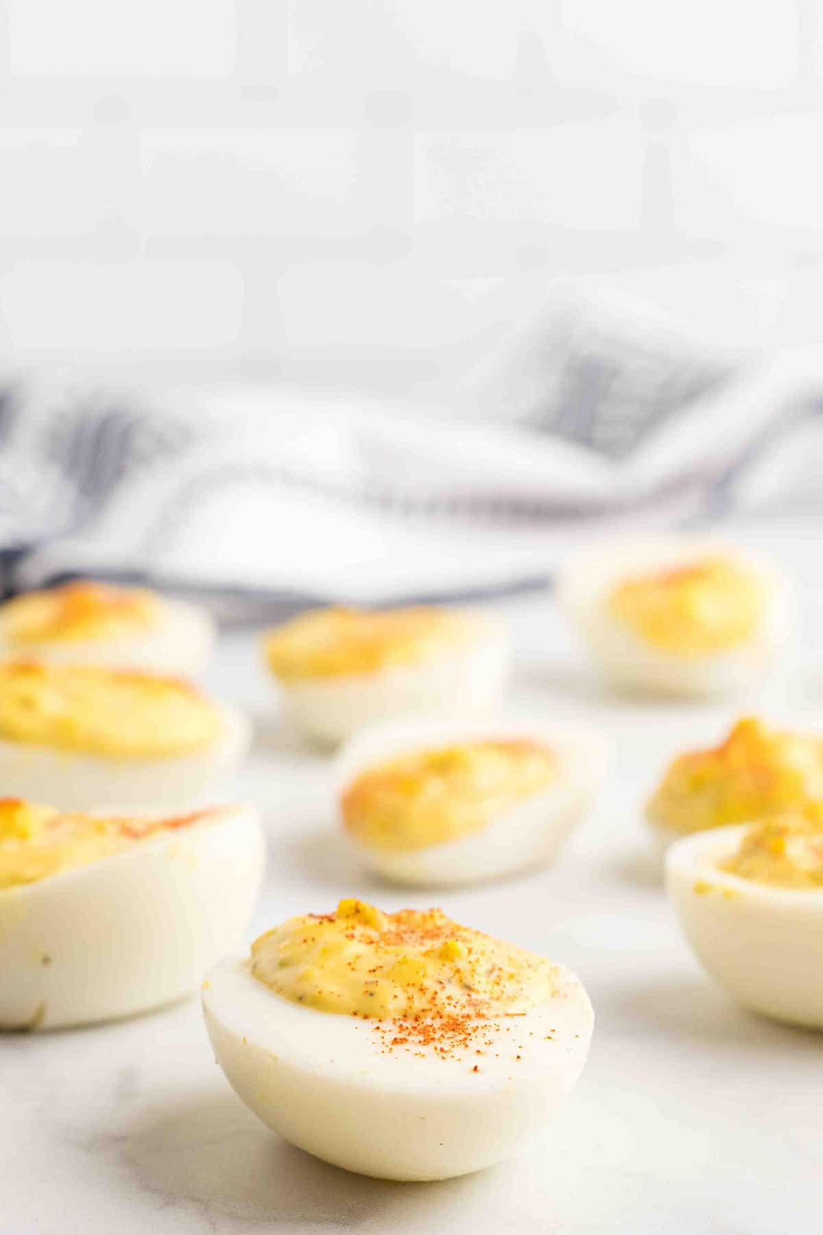 Finished deviled eggs on a white plate.