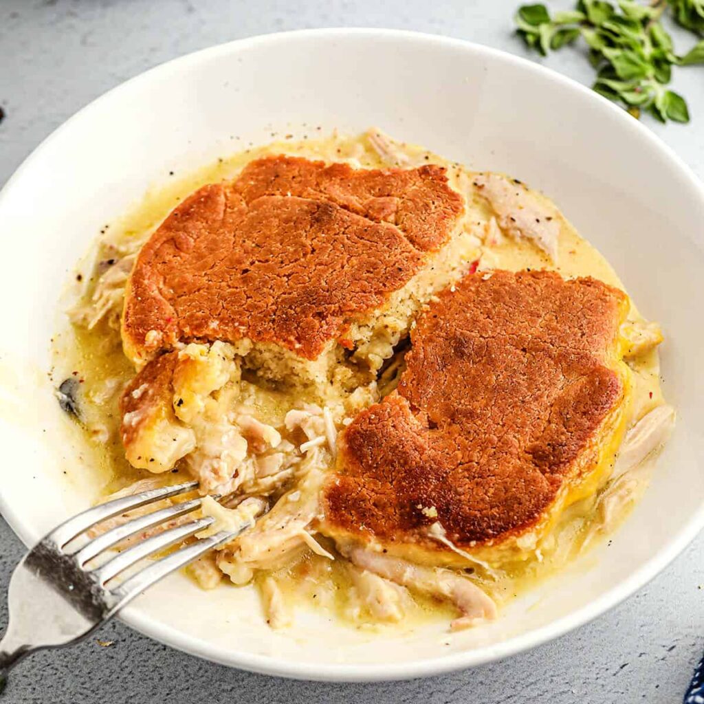 A serving of chicken pie in a white bowl.